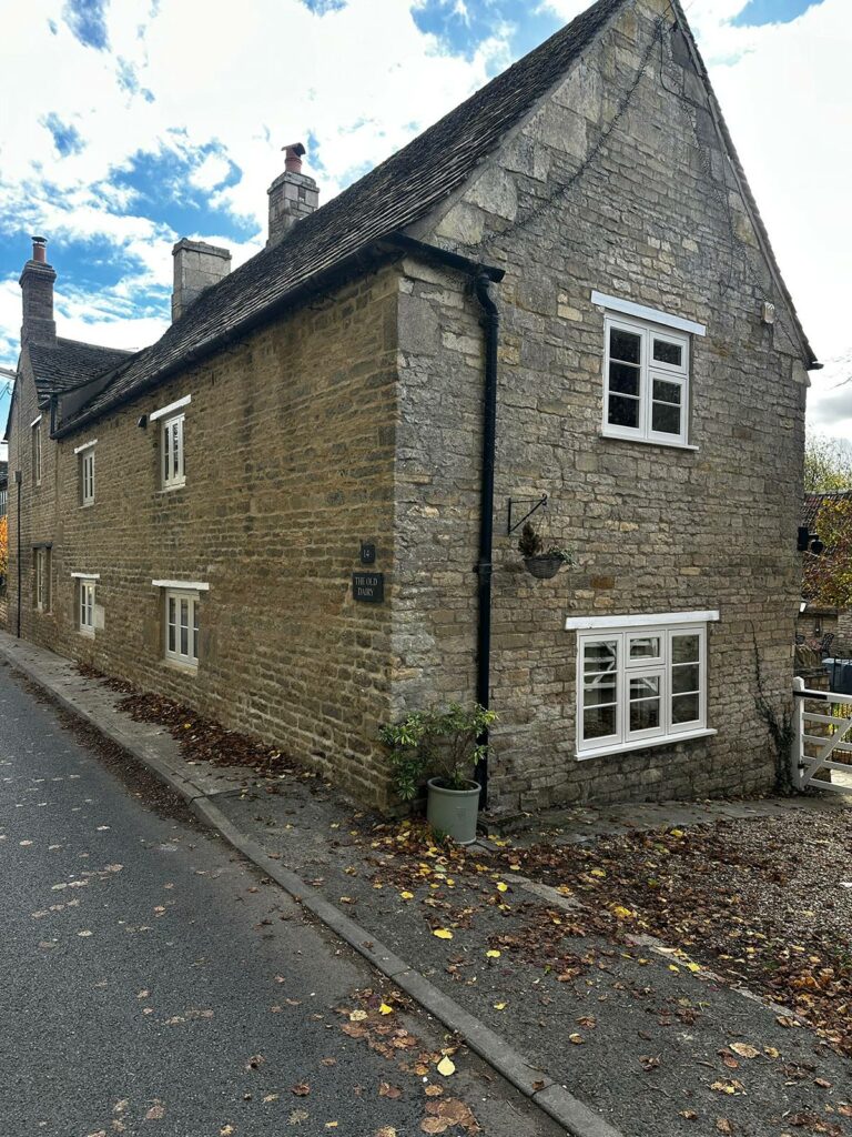 a roadside property with white windows