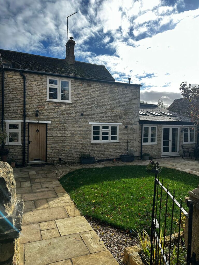 a large family home with white windows and doors