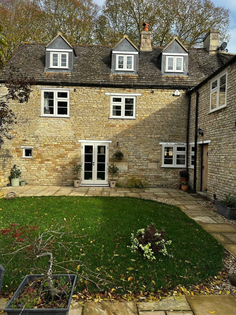 a large family home with white windows and doors