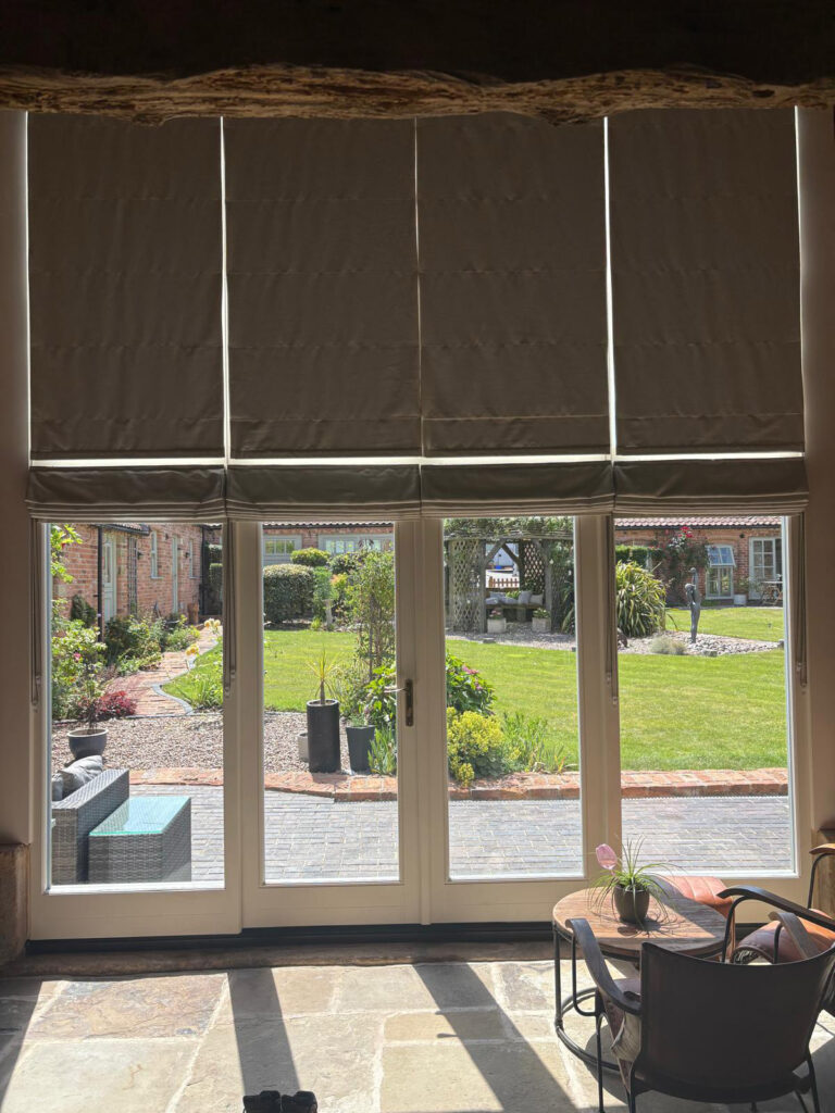 a set of fully glazed front doors beneath closed blinders