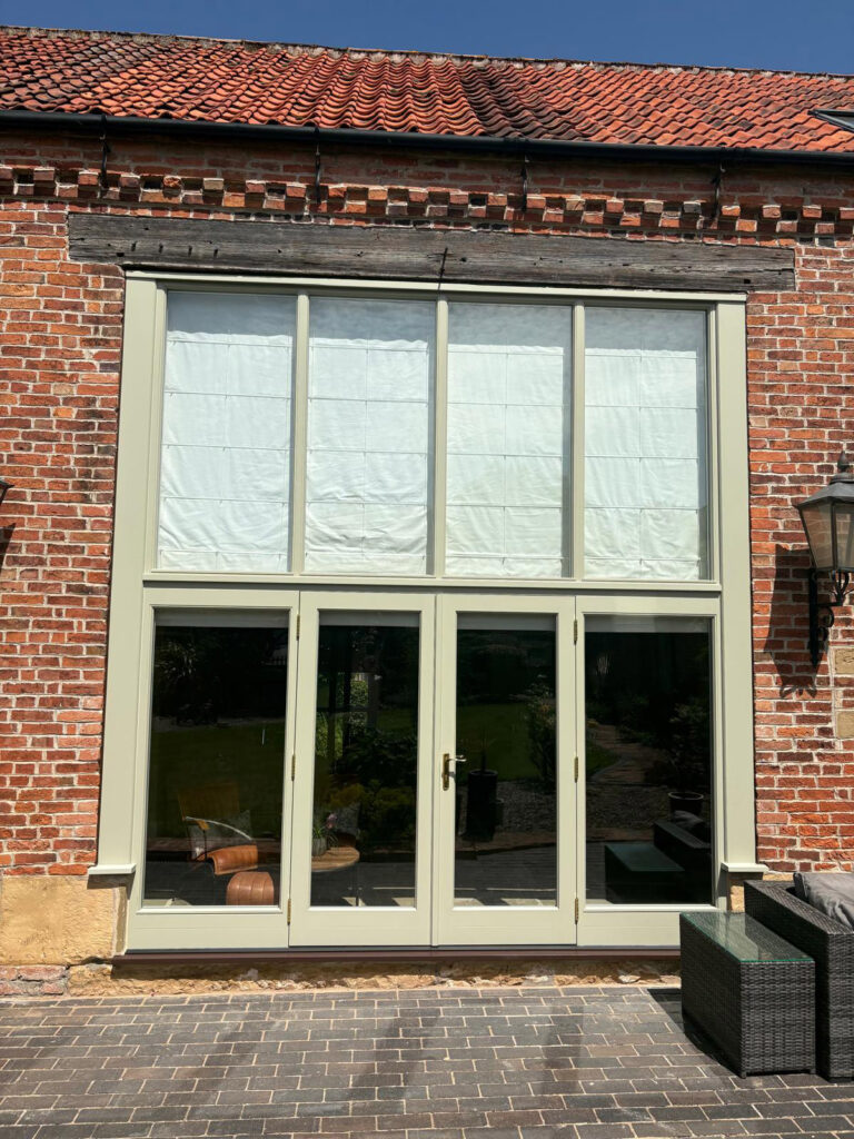 a large set of fully glazed french doors with oversized toplights