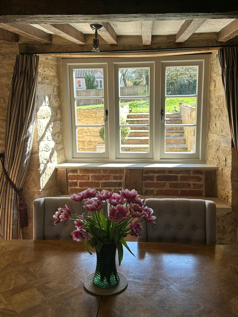 a dining room with white casement windows