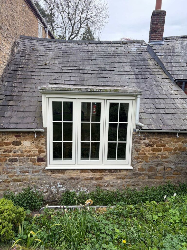 white casement windows with georgian bars on a stone property