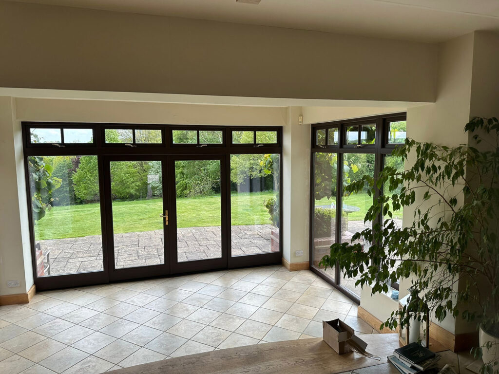 a large empty room with brown french doors