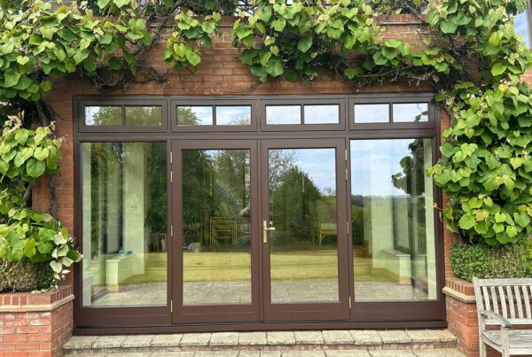 Dark brown french doors with fanlights