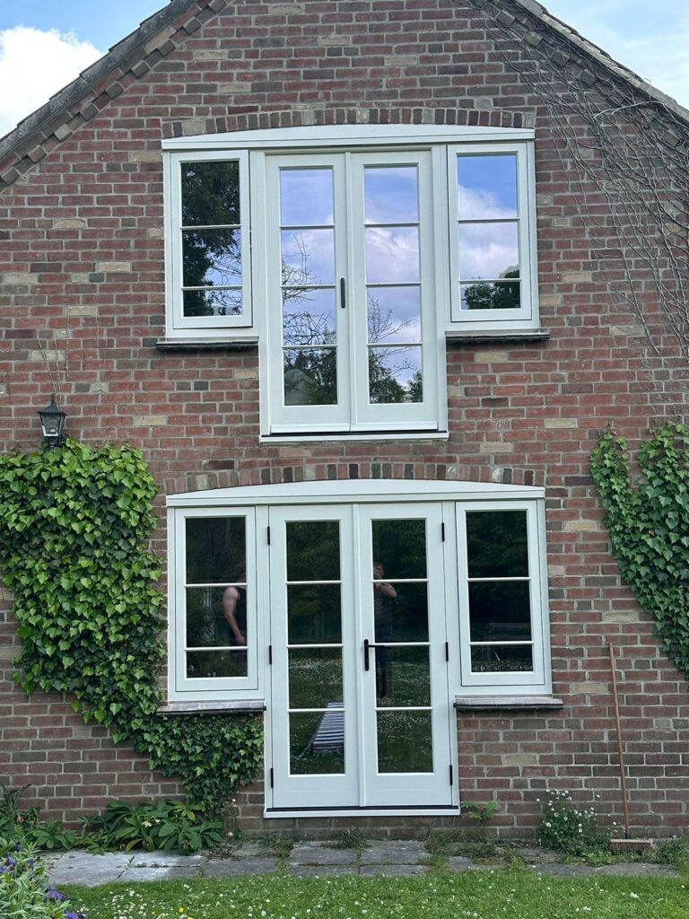 two sets of french doors on the side elevation of a house.