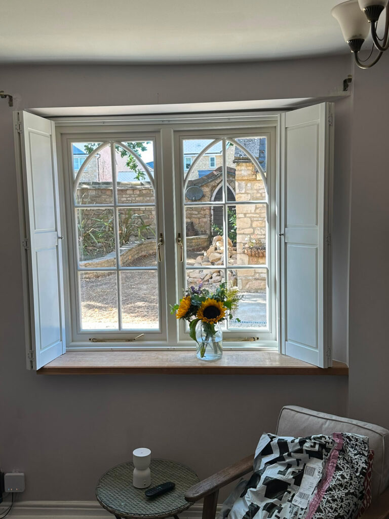 a white casement window with gothic glazing bars